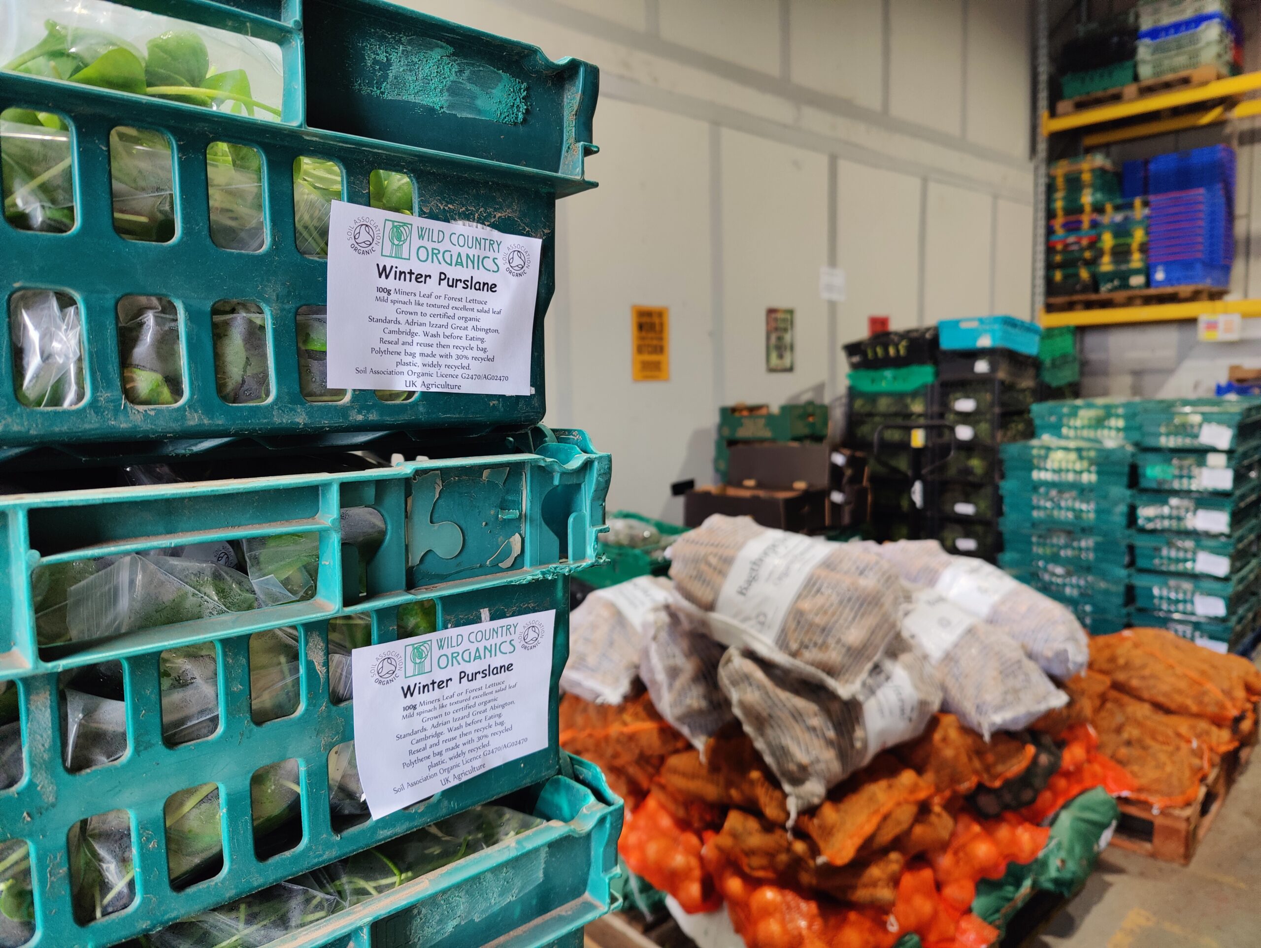 Deliveries at Better Food Shed Crates of salad leaves and sacks of vegetables in a warehouse