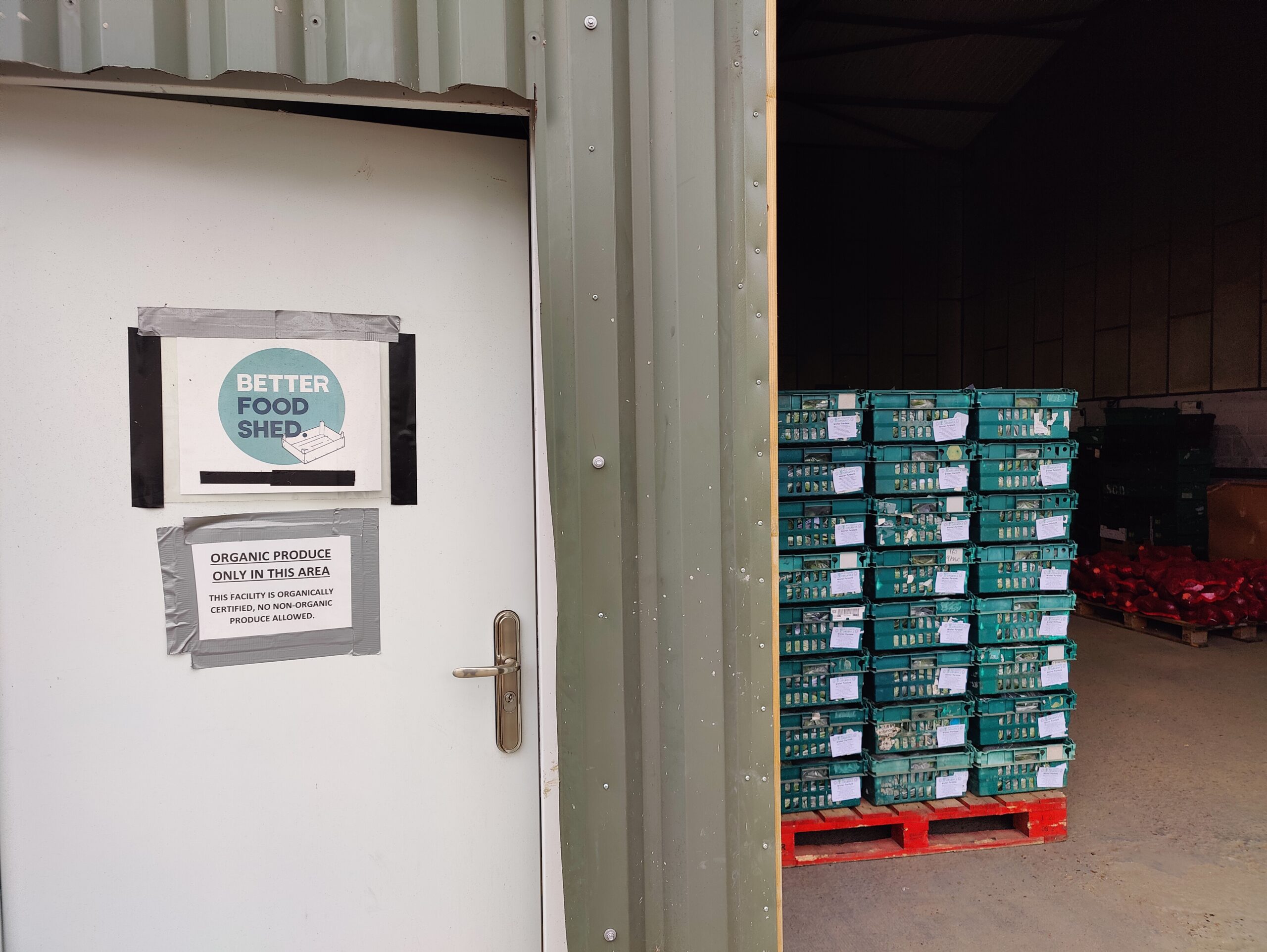 Signs at Better Food Shed Signs on the door at Better Food Traders stating that the whole warehouse follows organic certification requirements