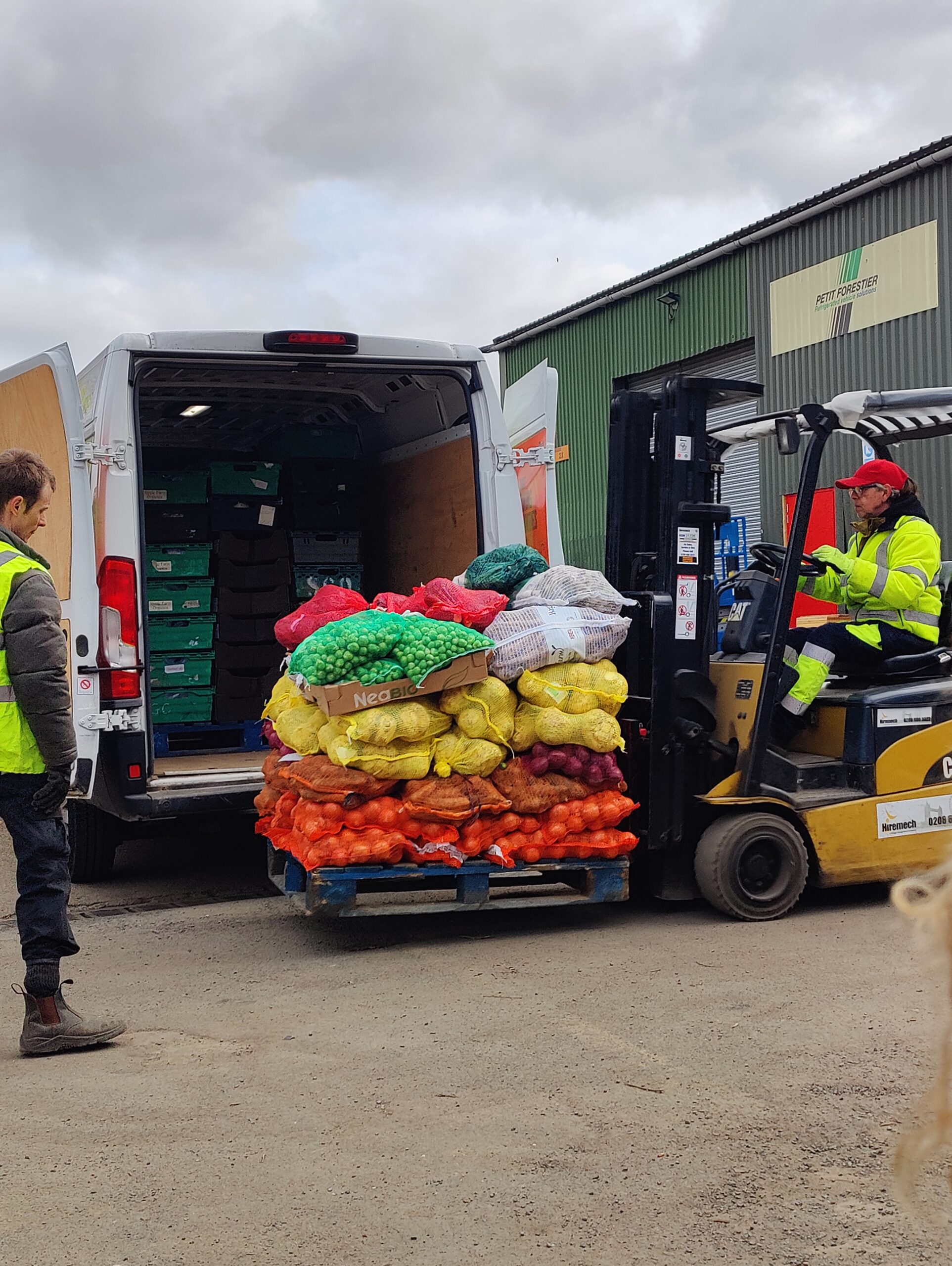 Forklift at Better Food Shed Forklift loading sacks of organic potatoes and onions onto an electric delivery van